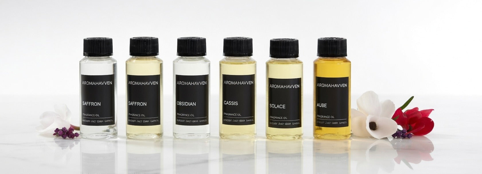 Hands holding an Aromahavven fragrance bottle